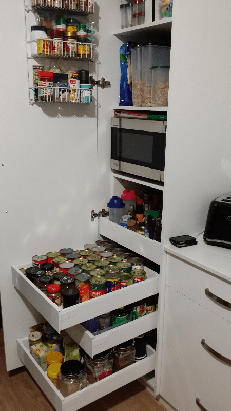 Tall Single door pantry with 4 pantry drawers and Microwave oven above supplied and installed by EAsy Access Kitchens